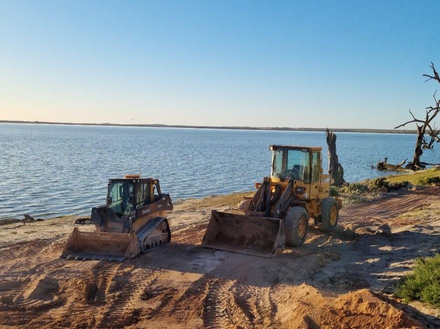 Altitude earthmoving machinery working beside the water